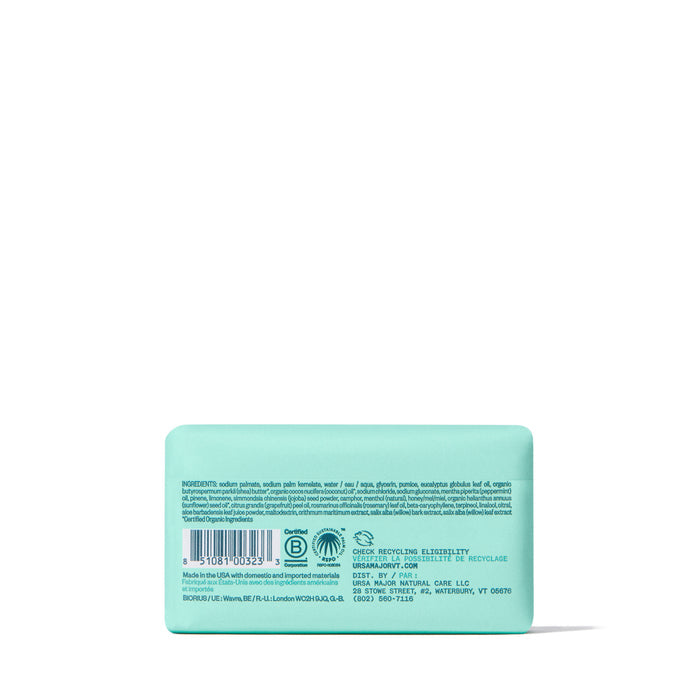 A turquoise rectangular Ursa Major Morning Mojo Bar Soap is centered on a white background, showing its back label with ingredients, certifications, and a barcode. This natural soap gently exfoliates for a refreshing cleanse.