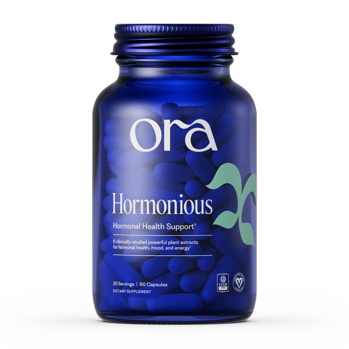 A blue bottle labeled Ora Organic Hormonious: Hormonal Balance & Support Capsules, vegan-certified for hormonal support, mood, and energy; contains 30 servings (90 capsules) with adaptogens to promote optimal wellness.