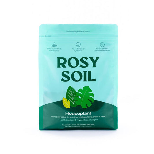 The Houseplant Potting Soil from Rosy Soil is a light turquoise bag adorned with green leaf illustrations. It boasts a living, peat-free soil mix with biochar for fungi, supports plant health, and features resealable, plant-based packaging for sustainability.