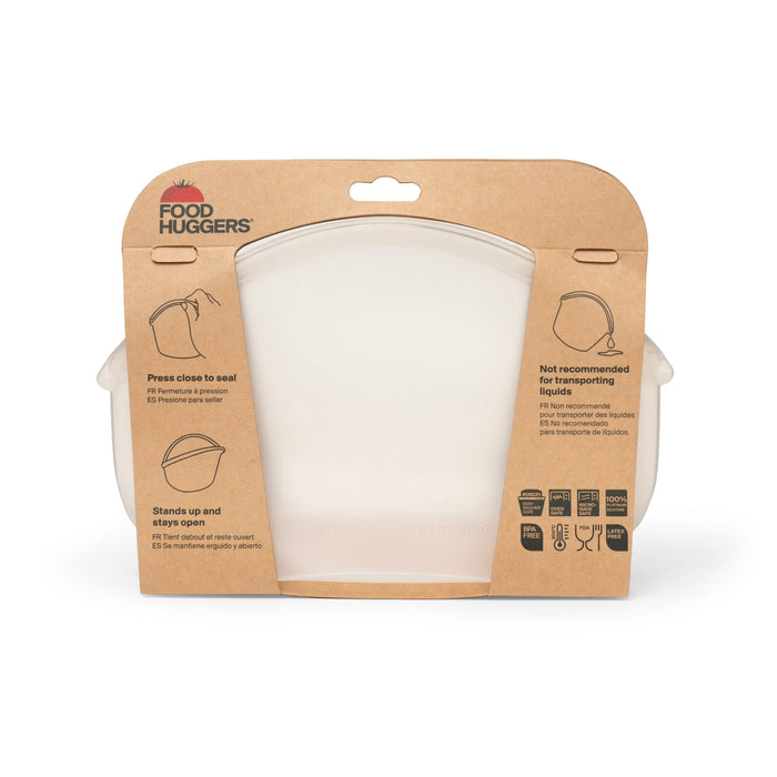 The Hugger Bag by Food Huggers comes in a clear container with a cardboard label, showcasing features like sealing, upright standing, and microwave and dishwasher safety. Icons and text highlight its sustainable, easy-to-clean design.