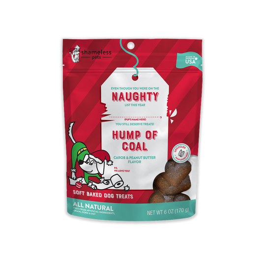 Shameless Pets Hump of Coal Soft Baked Biscuit Dog Treats, Naughty List comes in a festive red and green pouch with holiday graphics featuring a grinning dog in a Santa hat. These treats have natural carob and peanut butter flavors.