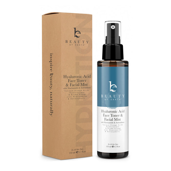 The Beauty by Earth Hyaluronic Acid Toner & Facial Mist, featuring niacinamide and antioxidants for moisture retention and a youthful complexion, comes with a black spray nozzle and is presented in brown cardboard packaging.