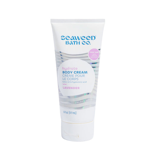 The Seaweed Bath Cos 6 fl oz Hydrating Body Cream showcases its organic skin care benefits in a white tube with a purple cap, highlighting ingredients like kukui oil and hyaluronic acid for a perfect hydrating experience.