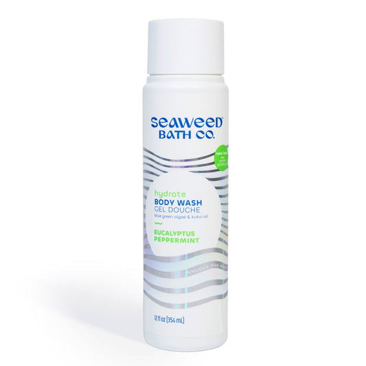 The Seaweed Bath Cos Hydrating Cleansing Body Wash, in a white bottle with wavy lines, features nutrient-rich oils and ingredients such as seaweed extract, blue-green algae, and kukui oil. It contains 12 fl oz (354 mL) with eucalyptus and peppermint scents.
