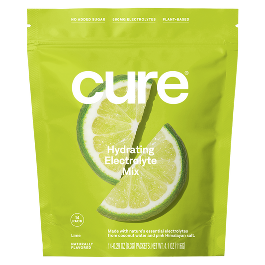 A vibrant green package of Cure Hydrations Hydrating Electrolyte Drink Mix features lime slice imagery, highlighting No Added Sugar, 850mg Electrolytes, and Plant-Based. With Coconut Water for a natural taste, each bag contains 14 packets.