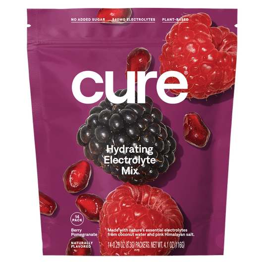 Cure Hydrations purple pouch of Hydrating Electrolyte Drink Mix features a berry pomegranate flavor with blackberries, raspberries, and pomegranate seeds on the package. Its plant-based with 540mg of electrolytes for quick absorption and contains no added sugar.