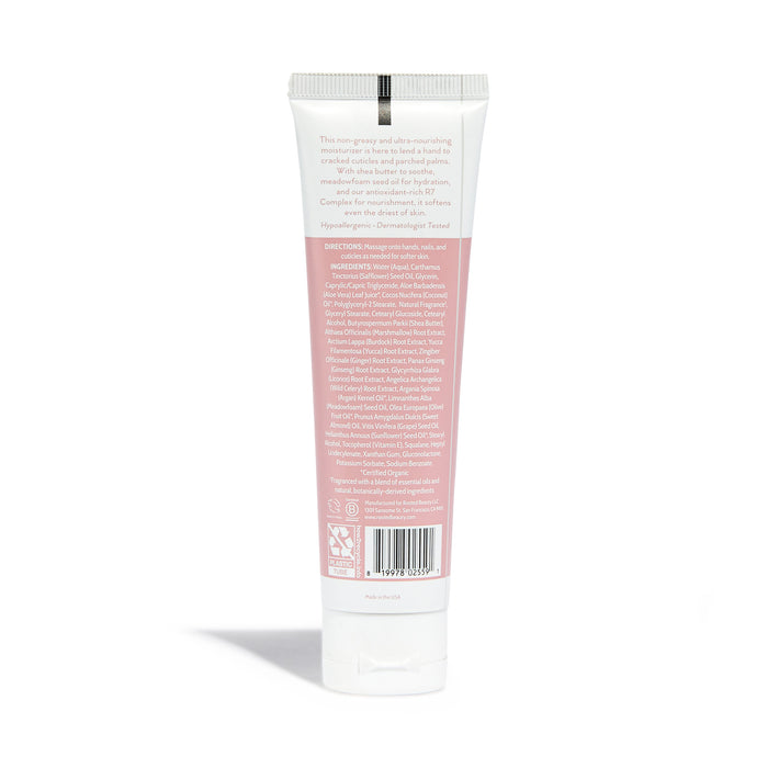 Rooted Beautys Hydrating Hand Cream comes in a pink and white tube enriched with shea butter. It has a cap and features printed usage directions and ingredients on the back label. Ideal for dry skin, it stands upright against a plain white background.