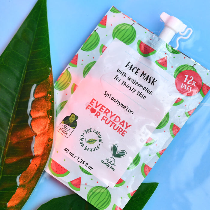 A flat lay image showcases the Everyday For Future Hydrating Watermelon Face Mask pouch adorned with watermelon illustrations on a pastel background. The packaging highlights its 40 ml size, 98% natural ingredients, and cruelty-free features. A leaf beside the pouch emphasizes its vegan skincare appeal.