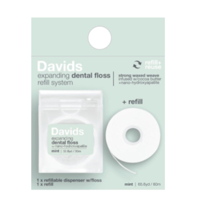 The Expanding Dental Floss and Refill with Hydroxyapatite by Davids includes mint floss with vegan wax, a refillable dispenser, and features a strong nano-hydroxyapatite weave infused with cocoa butter for an enhanced experience.