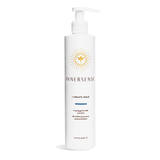A 10 fl oz tall white bottle of Innersense Organic Beautys I Create Hold styling gel, enriched with aloe and honey for antioxidant rejuvenation. It has a pump dispenser, a gold sunburst logo, and text promoting its hold and shine benefits.