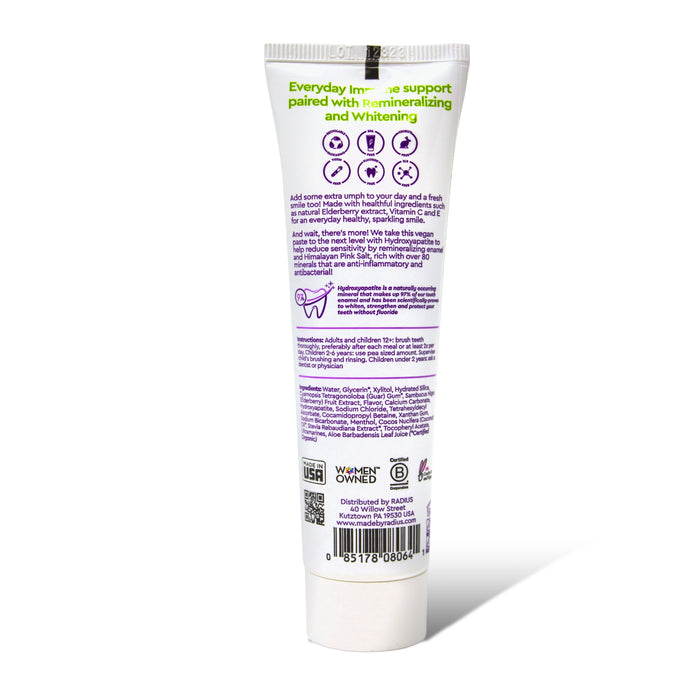A white Radius Immuni-Minty Adult Toothpaste tube stands upright on a white background, with green and purple text on the back listing ingredients like hydroxyapatite and elderberry, directions, certifications, and a barcode.