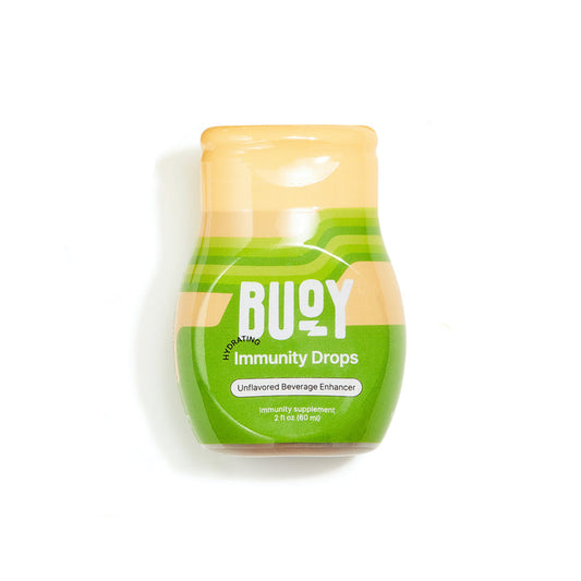 A 2 fl oz (60 ml) bottle of Buoy Hydrations Immunity Drops offers unsweetened electrolyte and immune support for any beverage. The green-and-orange packaging emphasizes its role as an immunity booster.