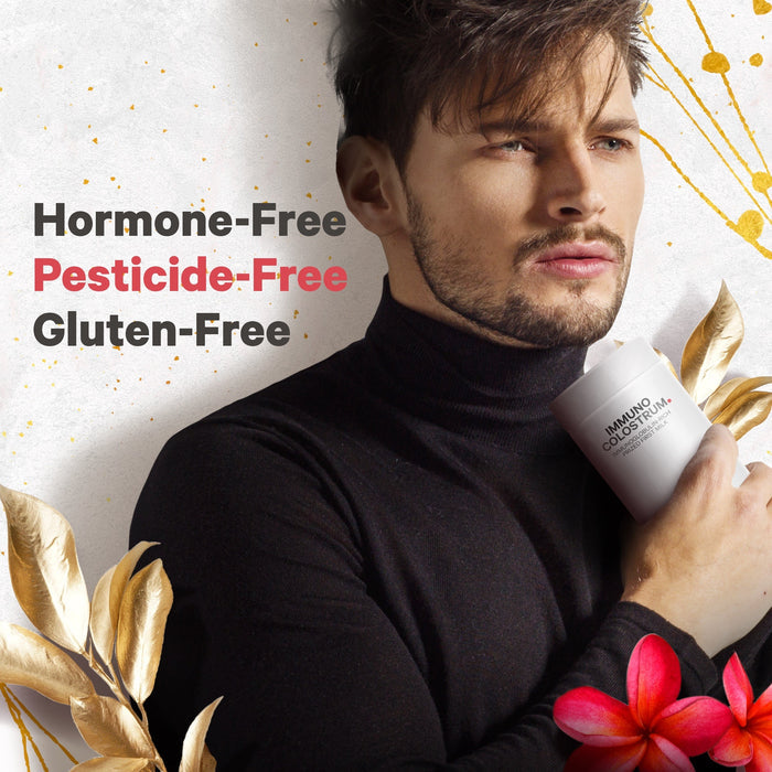 A bearded man wearing a black turtleneck holds a white container. Text beside him reads "Hormone-Free, Pesticide-Free, Gluten-Free" in different colors. Golden leaves and a red flower are at the bottom.