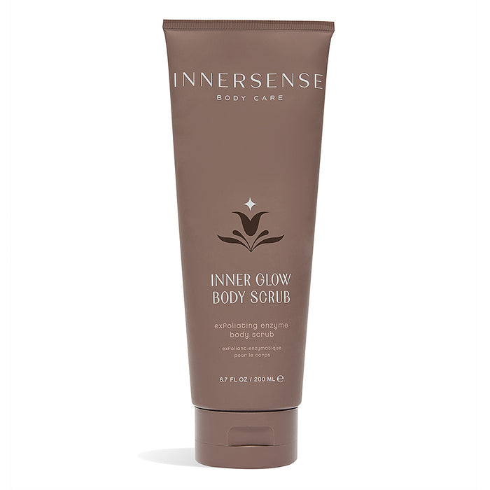 The 200 ml brown tube of Inner Glow Body Scrub by Innersense Organic Beauty features an exfoliating gel with enzymatic exfoliators and a subtle decorative label graphic.