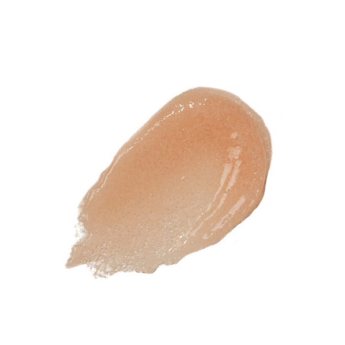 The Inner Glow Body Scrub by Innersense Organic Beauty is a glossy, peach-colored gel with a shimmering finish. Its smooth, slightly thick texture mimics healthy skin while enhancing its sheen with light reflection.