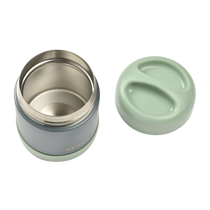 A gray stainless steel container with a light green lid and base is shown. The lid, next to the open jar, has two grip indentations. The shiny metal inside boasts the BEABA brand name on this reliable leak-proof Insulated Stainless Steel Food Container Jar for kids.