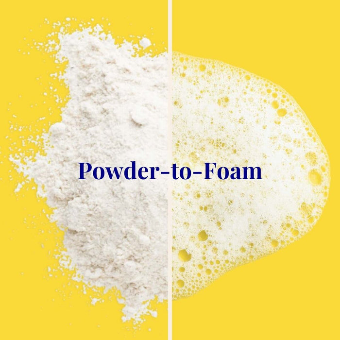 White powder on the left and foamy bubbles on the right against a yellow background, with Powder-to-Foam text in the center. Experience hair growth magic with The Powder Shampoos Invigorating & Stimulating Powder Shampoo, available in recyclable aluminum bottles for an eco-friendly touch.
