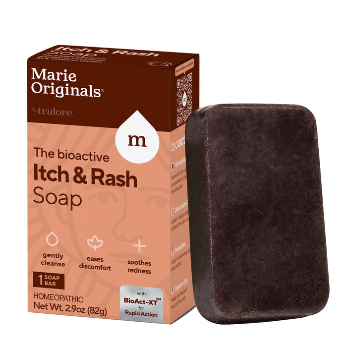 A box and an upright bar of Marie Originals Itch Relief Soap. The orange-brown box highlights benefits like gentle cleansing, soothing redness, and easing discomfort for sensitive skin. The soap bar is black.