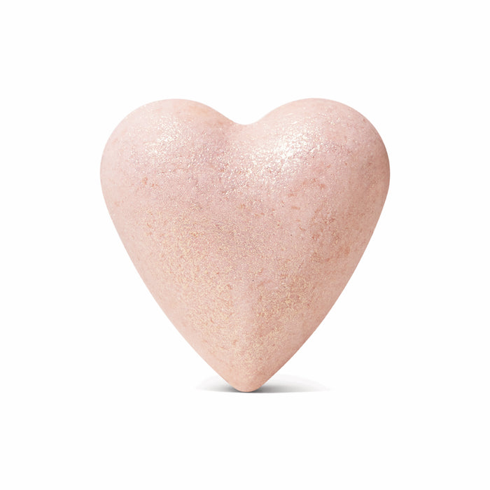 The Jasmine Gardenia Froth Bomb by Pacha Soap Co. is a pale pink, heart-shaped bath bomb with a shimmery surface and rose clay, shown against a plain white background.