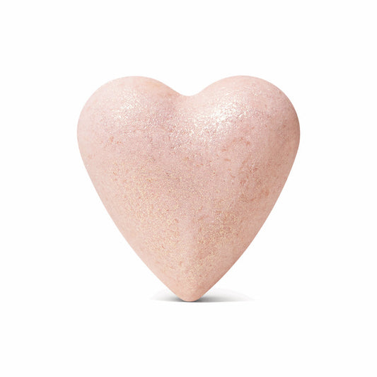 The Jasmine Gardenia Froth Bomb by Pacha Soap Co. is a pale pink, heart-shaped bath bomb with a shimmery surface and rose clay, shown against a plain white background.