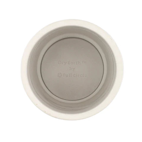 Top view of a cream-colored round bowl made from diatomaceous earth, branded Keep It Clean Toothbrush Holder Dry Earth Refill by Full Circle. The smooth, slightly concave interior is an ideal bathroom essential with natural antibacterial properties.