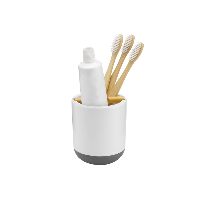 The Keep It Clean Toothbrush Holder by Full Circle is a sleek, minimalist white holder with a flat, dark base that fits three bamboo toothbrushes and a toothpaste tube. It features an integrated bamboo divider for organized, eco-friendly storage.