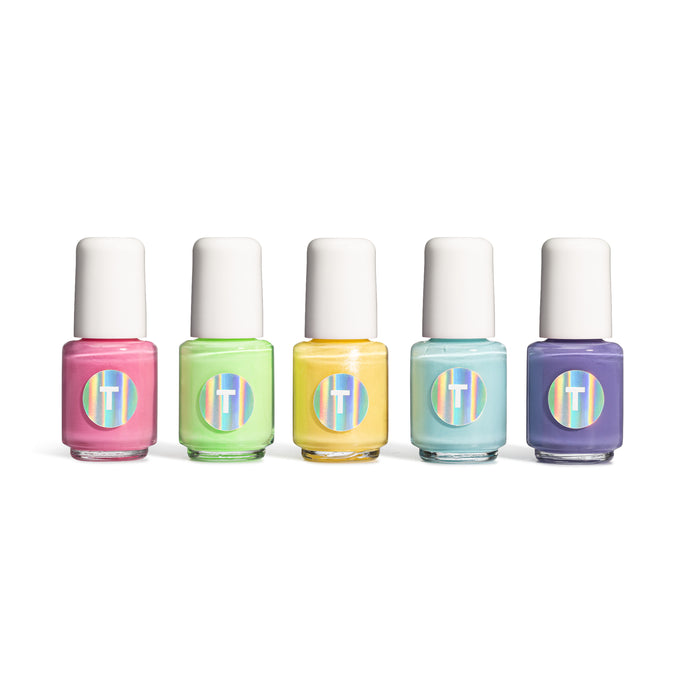 The Kids 5-Piece Fun Pop Nail Collection by Terra Beauty Bars features pastel shades of pink, green, yellow, blue, and purple. Each vegan, cruelty-free bottle is topped with a white cap and iridescent label, forming a 10-free nail set against a pristine white background.