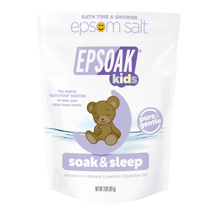 A white San Francisco Salt Co Kids Epsom Salts - Soak & Sleep Bath Salts bag with a cartoon teddy bear and lavender accents offers a pure, gentle bath soak infused with natural lavender essential oil for relaxing kids’ bath time.