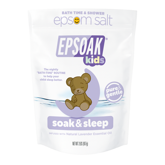 A white San Francisco Salt Co Kids Epsom Salts - Soak & Sleep Bath Salts bag with a cartoon teddy bear and lavender accents offers a pure, gentle bath soak infused with natural lavender essential oil for relaxing kids’ bath time.