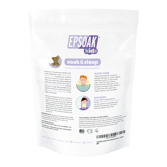Back of a white San Francisco Salt Co Kids Epsom Salts - Soak & Sleep Bath Salts bag, showing product info, usage for bath and shower, cruelty-free claims, plus a teddy bear and child illustrations bathing and showering.