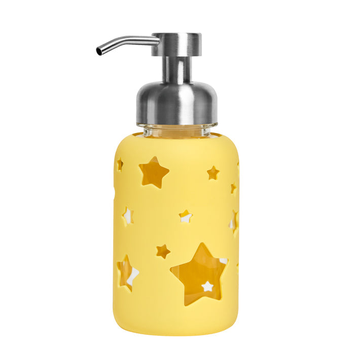 The Kids Foaming Hand Soap Glass Dispenser by Grove Co. features a yellow design with star cutouts and a metallic pump. This reusable glass dispenser complements your bathroom decor while helping eliminate plastic waste, offering an eco-friendly solution.