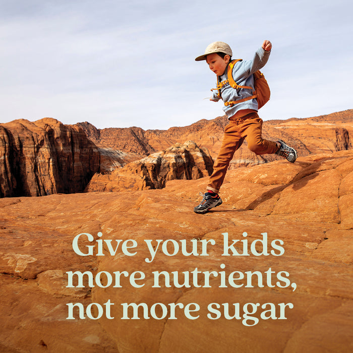A young child with a backpack runs on red rocky terrain. Text reads: Fuel their adventures with New Chapter Kids Multivitamin Gummies—nutrient packed, less sugar, and berry citrus flavored theyll love.