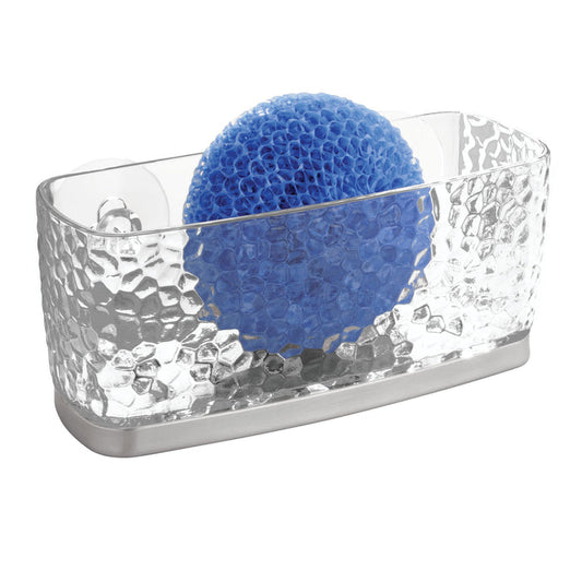 The iDesign Kitchen Sink Sponge Suction, crafted from recycled plastic, includes a blue round dish scrubber with a mesh-like surface and a textured design. The transparent holder rests on a sleek silver-colored base.