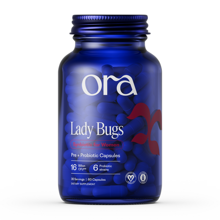 A blue Ora Organic Lady Bugs: Synbiotic for Women bottle has 60 capsules with 16 billion CFU and 6 probiotic strains to support vaginal health, plus several certification icons at the bottom of the label.