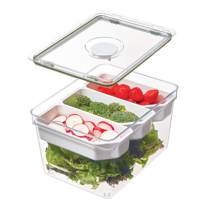 The Large Produce Bin with 3 Dividers by iDesign, crafted from recycled plastic, is a transparent food storage container featuring an open lid that reveals its sections filled with strawberries, broccoli, sliced radishes, and lettuce.