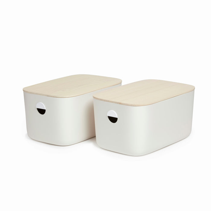 Two white, rectangular Large Storage Bins by Open Spaces feature light wood lids and round cut-out handles, set against a plain white background. These durable, stackable bins blend style and functionality effortlessly.