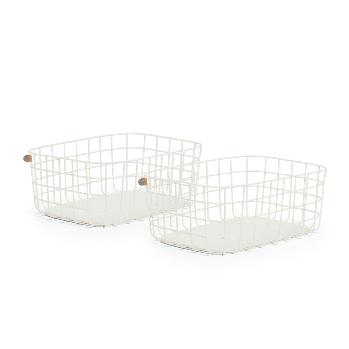 The Large Wire Baskets from Open Spaces are two high-quality steel wire baskets featuring rectangular bases, rounded corners, and small circular leather accents. They are perfect for stylishly storing large blankets against a plain white background.