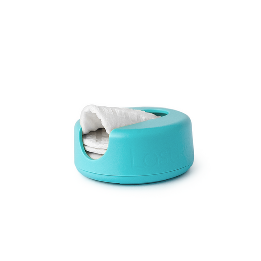 The LastRound by LastObject comes in a turquoise container with a smooth, rounded design that reveals reusable cotton rounds through an opening, offering an eco-friendly option for sustainable beauty practices.
