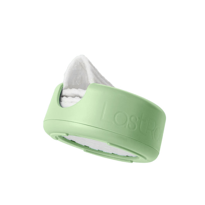 LastRound by LastObject offers a sustainable beauty solution with its eco-friendly green container, housing reusable cotton rounds that resemble rolled white cloths. A stylish cut-out opening reveals the cloths inside, highlighting both function and design.
