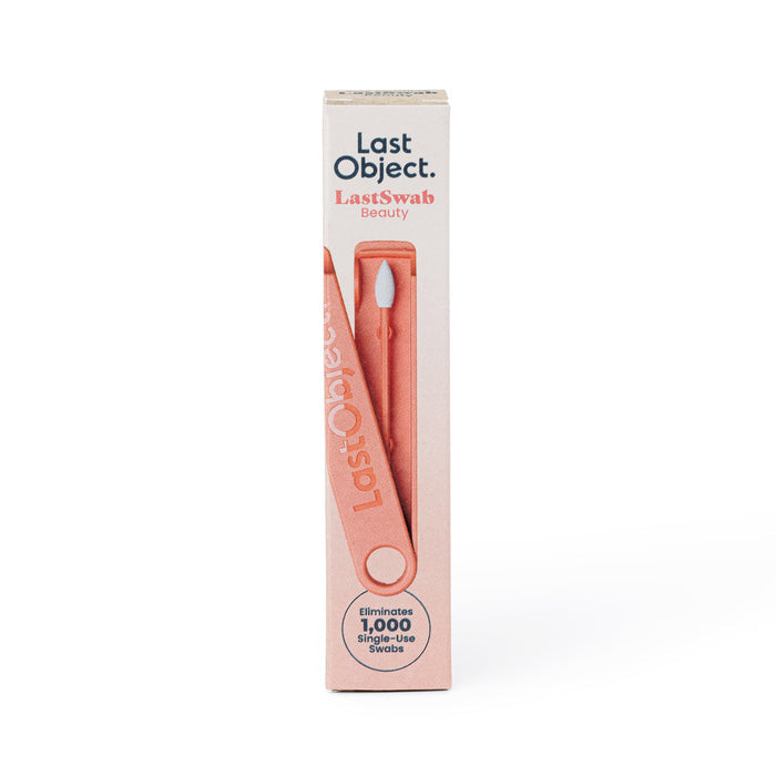 The image shows a rectangular box of LastObjects eco-friendly LastSwab Beauty. It features a reusable swab with pink tips and comes with a carrying case, ideal for makeup application. Packaging emphasizes its capacity to replace 1,000 single-use swabs.