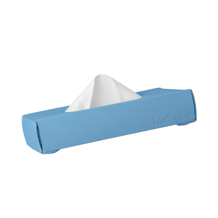 The LastTissue Box by LastObject is a blue rectangular silicone case holding partially pulled organic cotton tissues. This eco-friendly tissue box merges sustainable design with convenience, providing a chic, reusable alternative to single-use products.