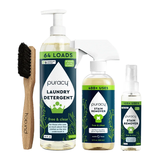 Explore the Laundry Essentials Bundle, which includes a wooden brush, laundry detergent, and stain removers set against a green background. Enhance your laundry routine and combat stubborn stains with our eco-friendly solution.