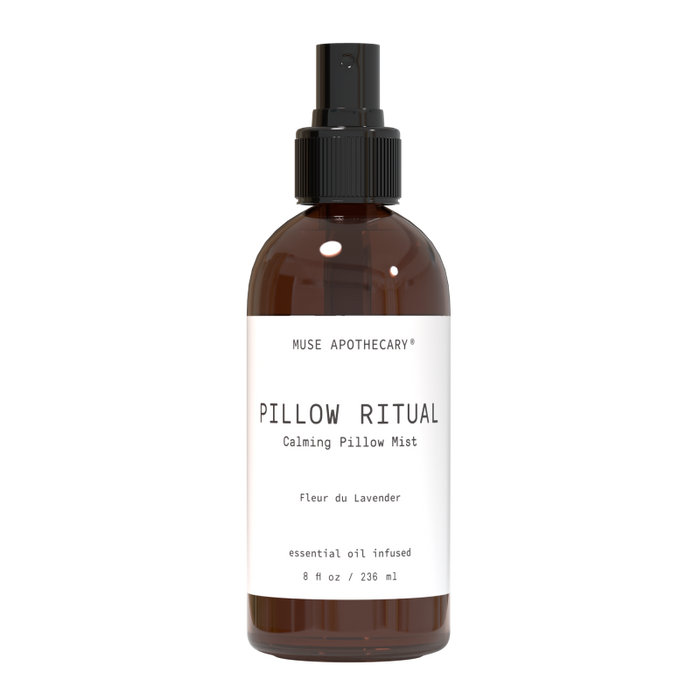 A 236 ml bottle of Muse Apothecarys Linen, Pillow and Fabric Spray aromatherapy mist with lavender essential oil. This sleek dark amber bottle with a white label and black spray cap is made from natural ingredients to boost relaxation.