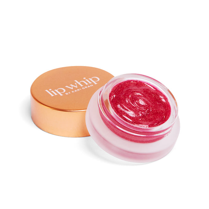 A small open jar of Kari Grans Lip Whip Color Balm, shimmering red with a gold lid, crafted using natural ingredients.