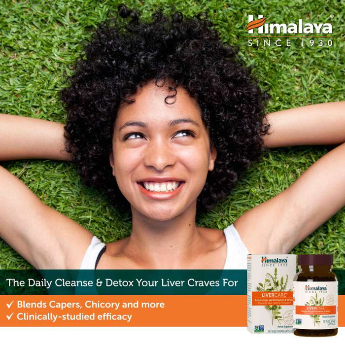 A smiling person lies on grass with their hands behind their head. Text reads "Himalaya Since 1930" and "The Daily Cleanse &amp; Detox Your Liver Craves For." Products and benefits are shown: "Blends Capers, Chicory and more" and "Clinically-studied efficacy." There is an image of Himalaya LiverCare products.