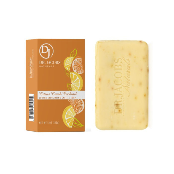 A 5 oz orange and white box of Dr. Jacobs Naturals Loofah Exfoliating Bar Soap featuring citrus slice illustrations sits beside a yellow bar enriched with organic shea butter. The soap, speckled with small flecks and the embossed brand name, is included. Net weight: 142 g.