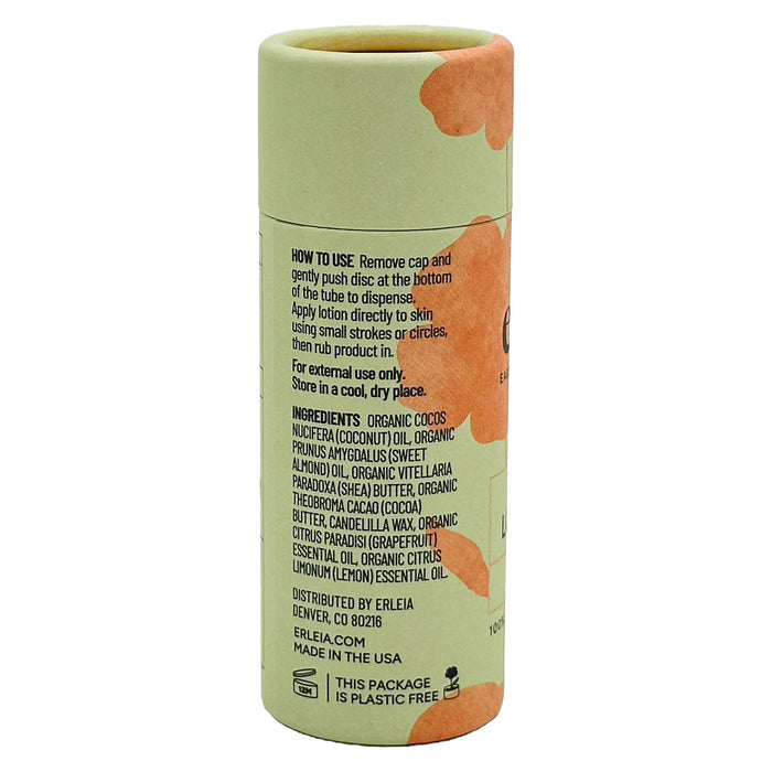 A plastic-free cylindrical tube with a green and orange-brown design displays instructions and ingredients for Erleias Lotion Bar, made with organic coconut oil, cocoa butter, shea butter, and essential oils. Proudly made in the USA.
