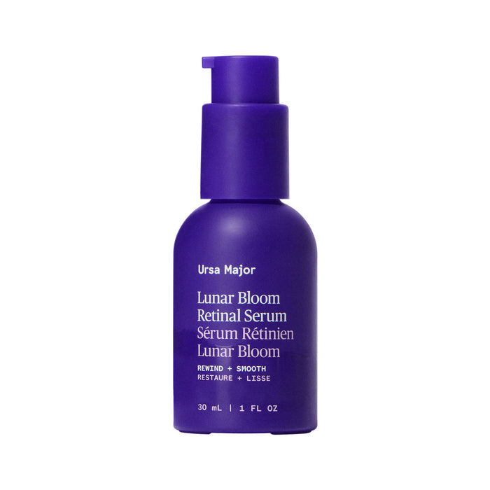 A 30 mL (1 fl oz) purple bottle of Ursa Major Lunar Bloom Retinal Serum with a pump dispenser features white text on the label and is ideal for evening skin texture and minimizing fine lines.