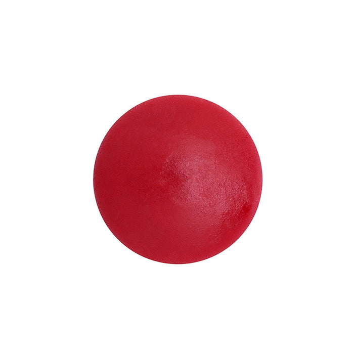 On a plain white background, a smooth red rubber ball stands out, mirroring the vibrant color of Henné Organics Luxury Lip Tint.