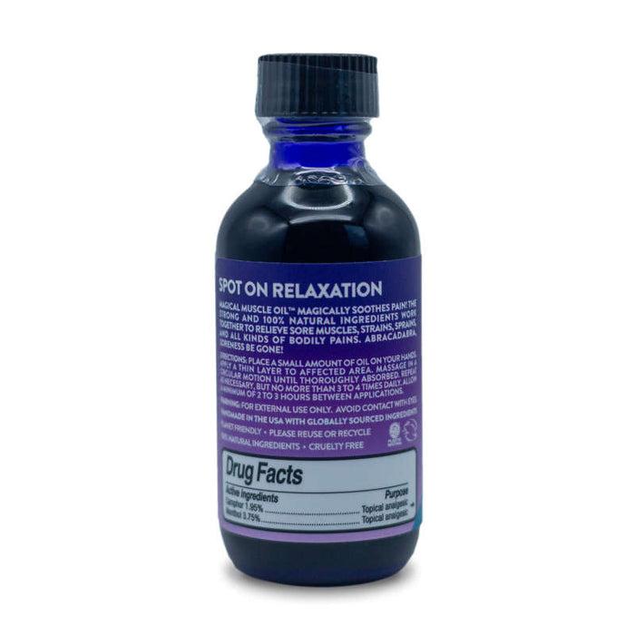 A dark blue bottle of Magical Muscle Oil™ by Little Moon Essentials, featuring a purple label, highlights natural pain relief ingredients. The capped bottle stands against a plain white background, showcasing its uses and benefits.